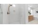 Bright bathroom features white tile shower with glass door and wood vanity with stone countertop at 1991 W Bartlett Ct, Chandler, AZ 85248