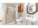 Bathroom with glass-enclosed shower, pedestal sink, decorative mirror, and tile flooring at 1991 W Bartlett Ct, Chandler, AZ 85248