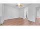Bright bedroom features wood-look flooring, an archway to an ensuite, and a large window at 1991 W Bartlett Ct, Chandler, AZ 85248