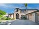 Beautiful two-story home with a well-manicured lawn, arched entryway, and a spacious three-car garage for ample parking at 1991 W Bartlett Ct, Chandler, AZ 85248