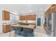 Bright kitchen with wood cabinets, stainless steel appliances, granite countertops, and a center island with seating at 1991 W Bartlett Ct, Chandler, AZ 85248