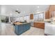 Open concept kitchen offers an island with gas range, wood cabinets, and lots of space at 1991 W Bartlett Ct, Chandler, AZ 85248