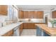 Bright kitchen featuring wood cabinets, stainless steel appliances, and a butcher block island at 1991 W Bartlett Ct, Chandler, AZ 85248
