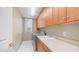 Laundry room features stainless steel washer and dryer, sink, cabinets and tile floors at 1991 W Bartlett Ct, Chandler, AZ 85248