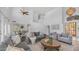 Bright living room with high ceilings, wood floors, neutral furniture and a staircase in the background at 1991 W Bartlett Ct, Chandler, AZ 85248