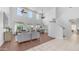 Open-concept living room with soaring ceilings and bright, airy windows adjacent to the staircase at 1991 W Bartlett Ct, Chandler, AZ 85248