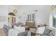 Bright living room with high ceilings, wood floors, neutral furniture and an ornate light fixture at 1991 W Bartlett Ct, Chandler, AZ 85248