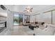 Bright living room with tile flooring, comfortable seating, and sliding door to a private pool at 1991 W Bartlett Ct, Chandler, AZ 85248