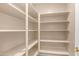 Walk-in pantry with white shelving providing ample storage space at 1991 W Bartlett Ct, Chandler, AZ 85248