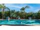 Backyard pool featuring vibrant turquoise water surrounded by lush tropical foliage and decorative tile accents at 1991 W Bartlett Ct, Chandler, AZ 85248