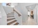 Bright staircase with wooden railing and steps, tiled floors and high ceilings with clerestory windows at 1991 W Bartlett Ct, Chandler, AZ 85248