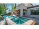 Beautiful swimming pool and spa area with a covered patio, set within a private backyard oasis with tropical greenery at 1991 W Bartlett Ct, Chandler, AZ 85248