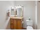 This bathroom has a single sink with a tiled backsplash, a three-light fixture, and neutral-toned decor at 20100 N 78Th Pl # 2193, Scottsdale, AZ 85255
