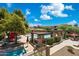 Community pool with seating areas, shaded pergola and lush landscaping at 20100 N 78Th Pl # 2193, Scottsdale, AZ 85255