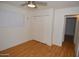 Bedroom showcasing wood floors, a window with blinds, a closet, and ceiling fan at 2015 E Southern Ave # 23, Tempe, AZ 85282