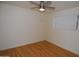 Bright bedroom with wood floors, a ceiling fan, and a window with blinds at 2015 E Southern Ave # 23, Tempe, AZ 85282