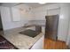 Stylish kitchen featuring granite counters, white cabinets, and stainless steel refrigerator at 2015 E Southern Ave # 23, Tempe, AZ 85282