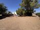 Gravel backyard with a large above ground pool and mature shade trees at 20644 N 36Th Ave, Glendale, AZ 85308