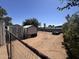 Backyard featuring two storage sheds, gravel landscaping, and chain link fence at 20644 N 36Th Ave, Glendale, AZ 85308