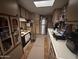 Galley kitchen featuring stainless steel refrigerator and abundant cabinet space at 20644 N 36Th Ave, Glendale, AZ 85308