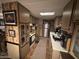 Galley kitchen featuring stainless steel refrigerator and abundant cabinet space at 20644 N 36Th Ave, Glendale, AZ 85308