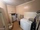 Functional laundry room with washer, freezer, and extra storage space at 20644 N 36Th Ave, Glendale, AZ 85308