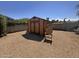 Backyard view of a small shed, gravel ground cover, and shady tree at 20644 N 36Th Ave, Glendale, AZ 85308
