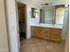 Bathroom with double sinks, a large mirror, and tile flooring at 2092 E Smoke Tree Rd, Gilbert, AZ 85296