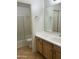 Bathroom featuring a single sink, updated vanity, and glass door shower-tub combo on a tile floor at 2092 E Smoke Tree Rd, Gilbert, AZ 85296