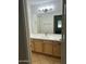 Well-lit bathroom featuring double sink vanity, bright countertop, tile floor, and well-placed towel rack at 2092 E Smoke Tree Rd, Gilbert, AZ 85296