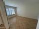 Bedroom with tile flooring and shuttered window providing natural light at 2092 E Smoke Tree Rd, Gilbert, AZ 85296