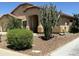 Beautiful home featuring desert landscaping, including a large cactus and rock accents, enhancing the curb appeal at 2092 E Smoke Tree Rd, Gilbert, AZ 85296