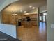 Well-lit kitchen featuring tile floors, a central island, and abundant wood cabinetry at 2092 E Smoke Tree Rd, Gilbert, AZ 85296