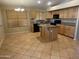 Eat-in kitchen with granite counters, central island, and black appliances at 2092 E Smoke Tree Rd, Gilbert, AZ 85296