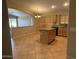 Spacious eat-in kitchen with tile floors, central island and open floor plan at 2092 E Smoke Tree Rd, Gilbert, AZ 85296