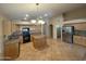 Spacious kitchen with a center island, granite countertops, stainless steel appliances, and ample cabinet space at 2092 E Smoke Tree Rd, Gilbert, AZ 85296