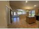 Open kitchen flows into living space, featuring granite countertops, a center island, and stainless steel appliances at 2092 E Smoke Tree Rd, Gilbert, AZ 85296