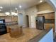 Bright kitchen featuring granite countertops, stainless steel appliances and central island at 2092 E Smoke Tree Rd, Gilbert, AZ 85296
