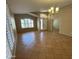 Open living room with tile flooring, window shutters, and a chandelier at 2092 E Smoke Tree Rd, Gilbert, AZ 85296