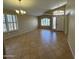 Bright living room features tile flooring and plenty of natural light, with space for dining and entertaining at 2092 E Smoke Tree Rd, Gilbert, AZ 85296