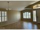 Bright Living Room with tiled floor, shutters, and decorative chandelier at 2092 E Smoke Tree Rd, Gilbert, AZ 85296