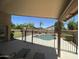 Covered patio overlooking a backyard oasis with a pool and lush greenery at 2092 E Smoke Tree Rd, Gilbert, AZ 85296
