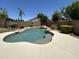 Inviting backyard pool with rock waterfall feature and mature landscaping at 2092 E Smoke Tree Rd, Gilbert, AZ 85296