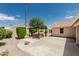 Wide backyard view featuring a hot tub under a pergola and a concrete patio at 20961 N 96Th Dr, Peoria, AZ 85382