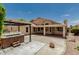 Large backyard features a covered patio, detached hot tub, and concrete patio area at 20961 N 96Th Dr, Peoria, AZ 85382