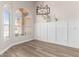 Bright dining room with beautiful wood floors, wainscotting, and large windows at 20961 N 96Th Dr, Peoria, AZ 85382
