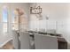 Elegant dining room with hardwood floors, large windows, modern chandelier and wainscotting at 20961 N 96Th Dr, Peoria, AZ 85382