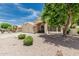 Inviting home with a three-car garage, lush trees, and meticulously maintained landscaping at 20961 N 96Th Dr, Peoria, AZ 85382
