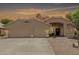 Charming single-story home featuring a three-car garage, tiled roof and well-manicured landscaping at 20961 N 96Th Dr, Peoria, AZ 85382