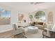 Cozy living room with neutral tones, modern decor, a cream sofa and abundant natural light at 20961 N 96Th Dr, Peoria, AZ 85382
